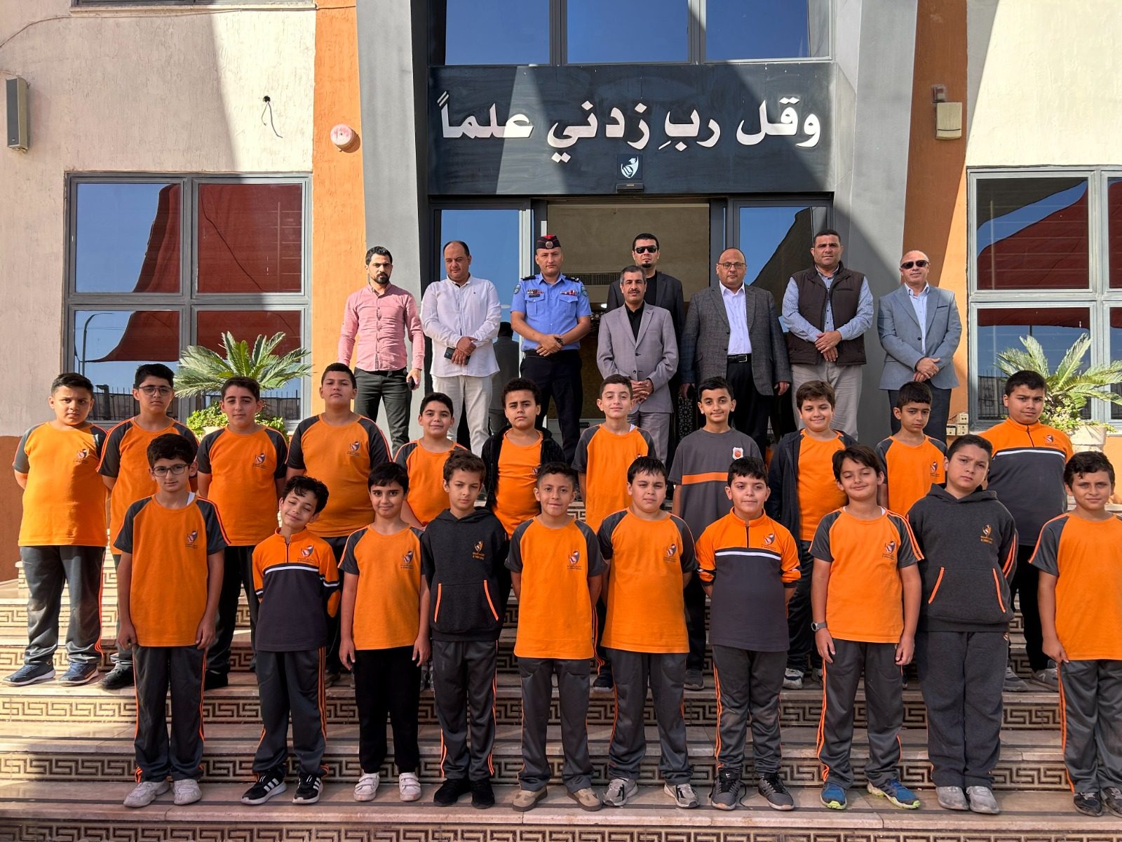 طلاب بالزي المدرسي أمام مبنى المدرسة